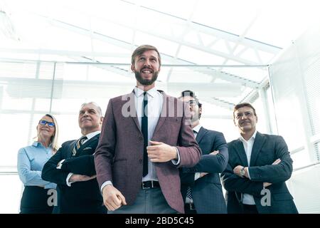 happy businessman with his business team standing in the office . Stock Photo