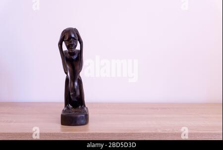 Luanda, Angola - April 04th 2020: Wood carving statue of The Thinker (O Pensador)  from Angola. Stock Photo