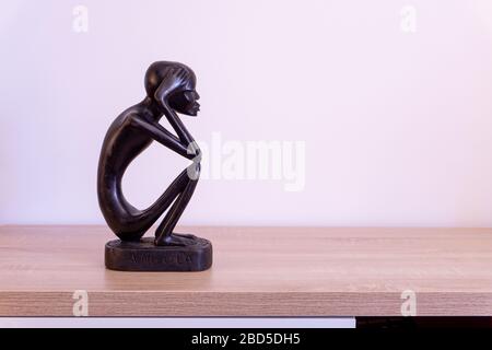 Luanda, Angola - April 04th 2020: Wood carving statue of The Thinker (O Pensador)  from Angola. Stock Photo