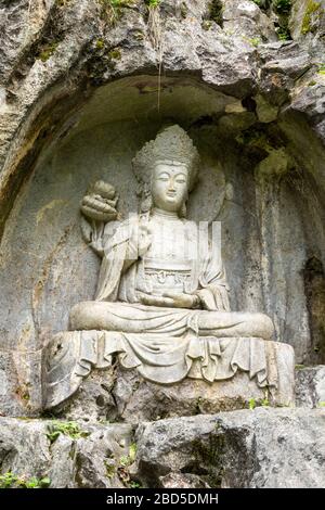 Buddha  rock-cut sculpture, Felai Feng grottoes, Lingyin Temple, West Lake, Hangzhou, China Stock Photo