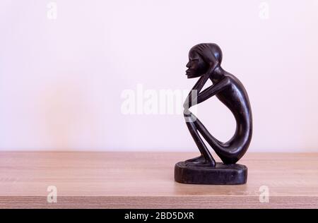 Luanda, Angola - April 04th 2020: Wood carving statue of The Thinker (O Pensador)  from Angola. Stock Photo