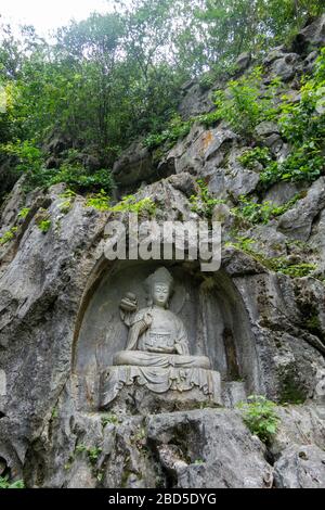 Buddha  rock-cut sculpture, Felai Feng grottoes, Lingyin Temple, West Lake, Hangzhou, China Stock Photo