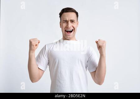 Happy man rejoices and celebrating winning, copy space Stock Photo