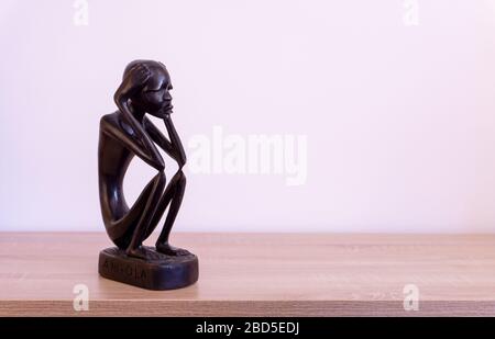 Luanda, Angola - April 04th 2020: Wood carving statue of The Thinker (O Pensador)  from Angola. Stock Photo