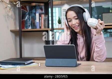 An asian women talking while video chatting with colleague. Stock Photo