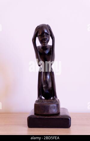 Luanda, Angola - April 04th 2020: Wood carving statue of The Thinker (O Pensador)  from Angola. Stock Photo