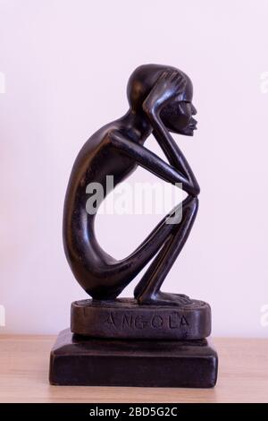 Luanda, Angola - April 04th 2020: Wood carving statue of The Thinker (O Pensador)  from Angola. Stock Photo