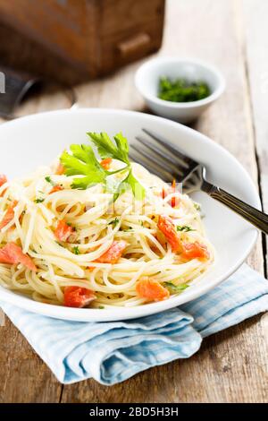 Spaghetti with smoked salmon and parsley Stock Photo