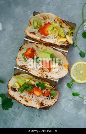 Homemade Chicken Tikka Tacos served in a metal Taco stand, selective focus Stock Photo