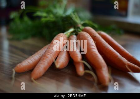 orange carrots on a table in the kitchen Stock Photo