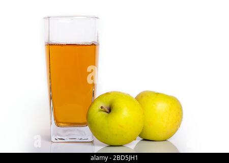 glass of apple juice and two apples on white background Stock Photo