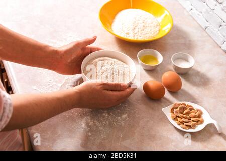 https://l450v.alamy.com/450v/2bd5k31/preparation-for-dough-mix-closeup-woman-hands-preparing-ingredients-for-baking-bread-or-cookies-in-bright-kitchen-with-marble-countertop-2bd5k31.jpg