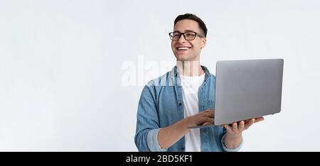 Laughing man in glasses and with laptop Stock Photo