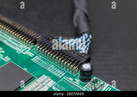Fragment of an electronic board on a repair table close-up. Motherboard electronic components Stock Photo