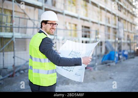 Young and attractive architect / civil engineer at work on a construction site Stock Photo