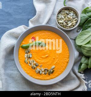 Homemade roasted vegetable pumpkin cream soup in bowl Stock Photo