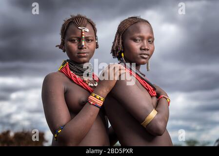 An unmarried woman, left, and married woman, right, member of the Dassanetch ethnic group or tribe, Omorate, southern Ethiopia. Stock Photo