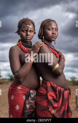 An unmarried woman, left, and married woman, right, member of the Dassanetch ethnic group or tribe, Omorate, southern Ethiopia. Stock Photo