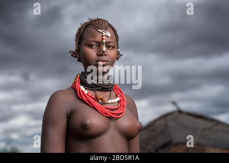 A young unmarried woman is member of the Dassanetch ethnic group or tribe, Omorate, southern Ethiopia. Stock Photo