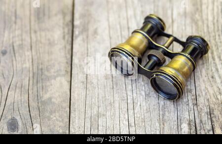 Binoculars on a wooden table, travel, discovery concept, web banner with copy space Stock Photo
