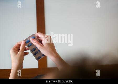 Female hand holding medical pills Stock Photo