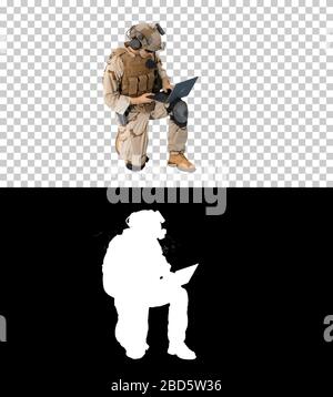 Soldier using laptop and Radio For Communication During Military Stock Photo