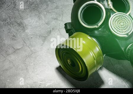 Gas mask on a black stone background, protection from dangerous infection. Stock Photo