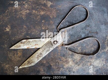 Cut concept, ancient opened scissors on metal background Stock Photo