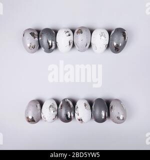 Easter eggs in two rows on grey background. copy space. Stock Photo