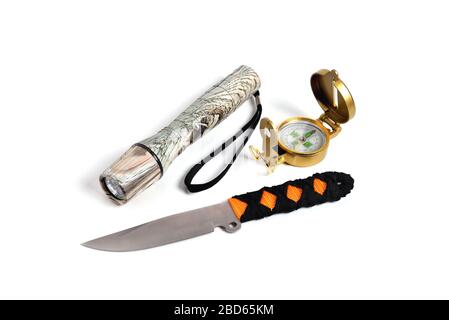 throwing knife camouflage flashlight and compass on a white background close-up Stock Photo