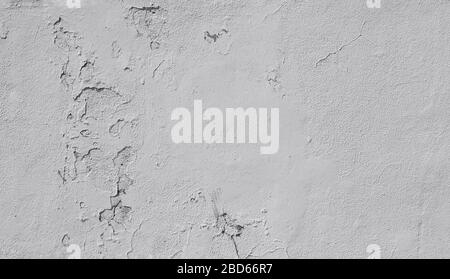 Close-up of a weathered and old concrete wall, paint is peeling off. High resolution abstract full frame textured background in black and white. Stock Photo