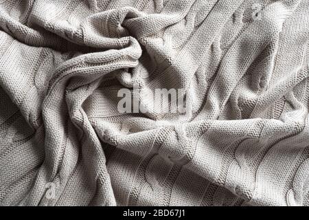 Texture gray knitted fabric with a pattern. Stock Photo