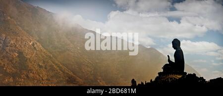 Tian Tan Buddha with mountains in the background, Ngong Ping, Lantau Island, Hong Kong. Stock Photo