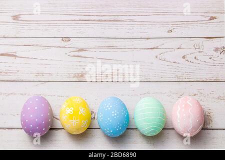 hand painted pastel colors eggs on light colored wooden table. easter background Stock Photo