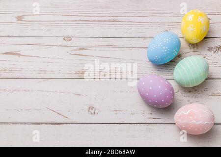 hand painted pastel colors eggs on light colored wooden table. easter background Stock Photo