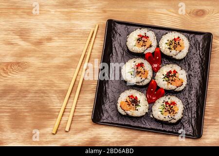 Korean roll Gimbap(kimbob). Steamed white rice (bap) and various other ingredients. Wooden boards background Stock Photo