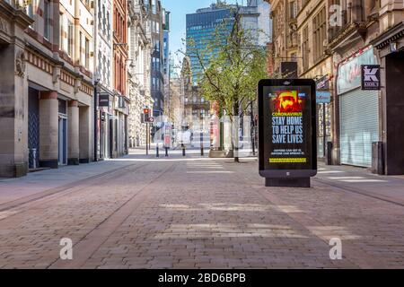 'Stay Home Save Lives' signs, Coronavirus Outbreak, King Street, Manchester City Centre, United Kingdom, April 2020. Stock Photo