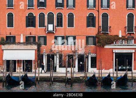 Venice, Italy - February 19 2020 : View of Grand Canal with gondolas and beautiful red building Stock Photo