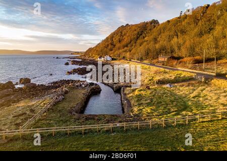 Northern Ireland, UK. Atlantic coast and Antrim Coast Road, a.k.a. Causeway Costal Route. One of the most scenic coastal roads in Europe. Aerial view Stock Photo