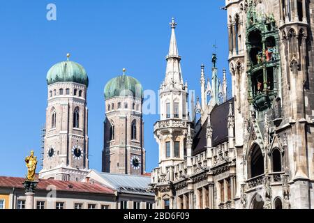 Landmarks of Munich at Marienplatz: Marienstatue (Statue of Mary), towers of Frauenkirche (Cathedral), New Town Hall (Neues Rathaus) with Glockenspiel