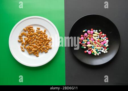 Many different weight loss pills and supplements as food on round white plate. Stock Photo