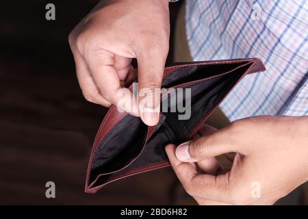 Empty wallet in the hands of an young man Stock Photo