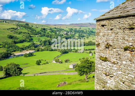 View over the river Swale towards Gunnerside village from Crackpot in Swaledale in The Yorkshire Dales National Park, England UK Stock Photo