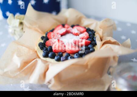 Raw vegan berry cheesecake gluten-free on a white wooden background Stock Photo