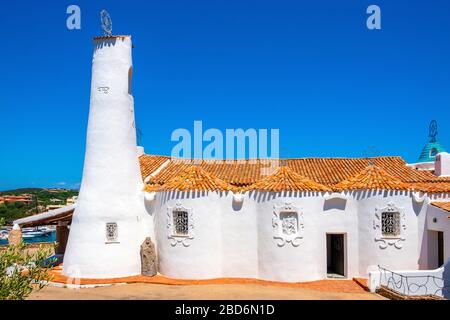 Porto Cervo, Sardinia / Italy - 2019/07/20: Chiesa Stella Maris church overlooking port and residences of Porto Cervo resort at the Costa Smeralda Stock Photo