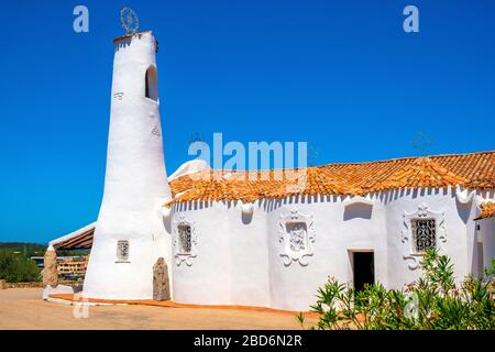 Porto Cervo, Sardinia / Italy - 2019/07/20: Chiesa Stella Maris church overlooking port and residences of Porto Cervo resort at the Costa Smeralda Stock Photo