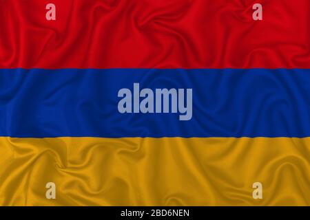 Armenia country flag on wavy silk textile fabric background. Stock Photo