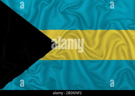 Bahamas country flag on wavy silk textile fabric background. Stock Photo