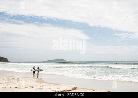 Surfers looking at the sea at Brava Beach. Florianopolis, Santa Catarina, Brazil. Stock Photo