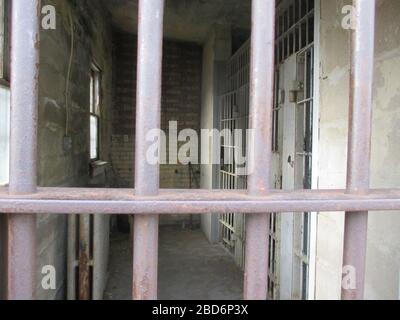 The inside of a old small jail up in Eureka Utah. This picture was taken standing outside looking in. Stock Photo